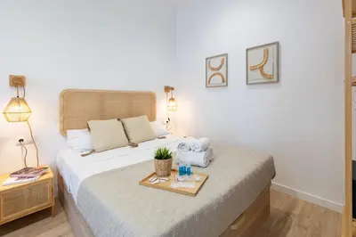 a bedroom with a bed with a tray with towels on it at Travel Habitat Ruzafa Lofts in Valencia
