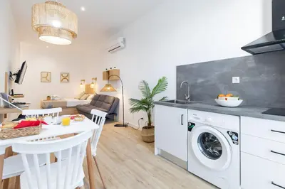 a kitchen and living room with a washing machine at Travel Habitat Ruzafa Lofts in Valencia