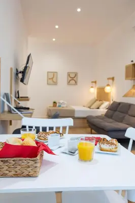a white table with food and drinks on it in a living room at Travel Habitat Ruzafa Lofts in Valencia