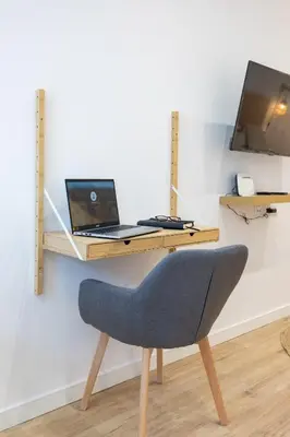 a desk with a laptop computer and a chair at Travel Habitat Ruzafa Lofts in Valencia
