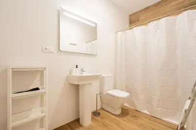 a white bathroom with a sink and a toilet at VisitVal Flats 1 in Valencia