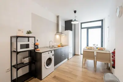 a kitchen with a washing machine and a microwave at VisitVal Flats 1 in Valencia