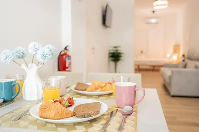 a table with two plates of breakfast foods and drinks at VisitVal Flats 1 in Valencia