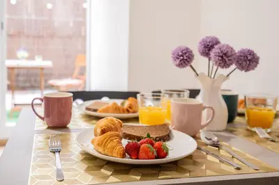 a table topped with a plate of food and fruit at VisitVal Flats 2 in Valencia
