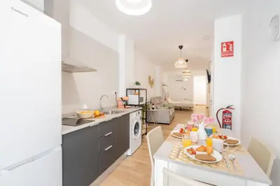 a kitchen with a table with food on it at VisitVal Flats 3 in Valencia