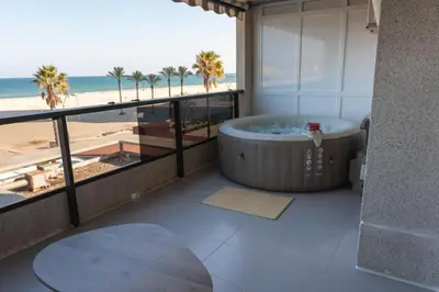 a bathroom with a tub and a view of the beach at Espacio2,1a línea,jacuzzi,piscina in Cullera