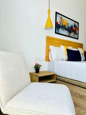 a bedroom with a bed and a chair and a table at New Industrial Design Flat in Russafa SOHO in Valencia
