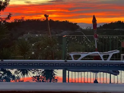 a boat in a pool with a sunset in the background at Finca El Escondite in Olocau