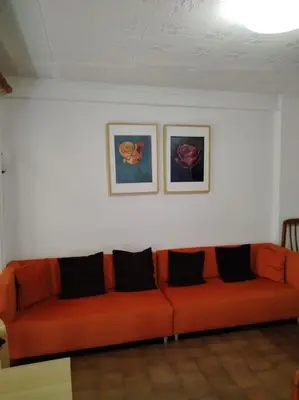 a small room with a chair and a wooden cabinet at Apartamento con parking frente a la playa in Faro de Cullera