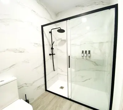 a shower with a glass door in a bathroom at Apartamento Ciencias & Maritim in Valencia
