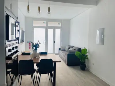 a living room with a table and a couch at Apartamento Ciencias & Maritim in Valencia