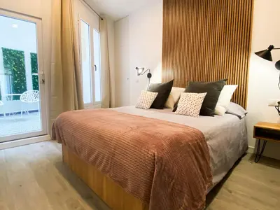 a bedroom with a bed and a large window at Apartamento Ciencias & Maritim in Valencia