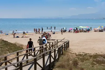 a group of people standing on a beach at Sea View Terrace Apartment Cullera in Cullera