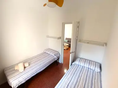 two beds in a room with a door open at Premium Beach Flat in Las Canteras