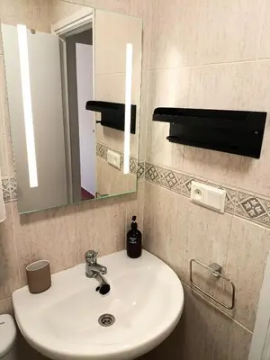 a bathroom with a sink and a mirror at Premium Beach Flat in Las Canteras
