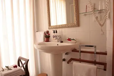 a bathroom with a sink and a mirror at Hostal Antigua Morellana in Valencia