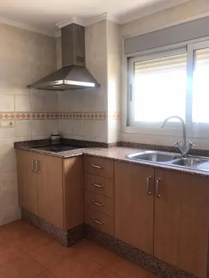 a kitchen with a sink and a counter top at Aloha frente al Mar in Cullera