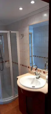 a bathroom with a sink and a shower at Aloha frente al Mar in Cullera
