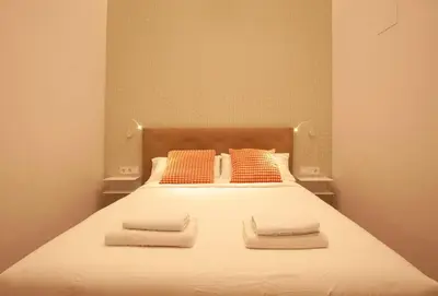 a bedroom with a bed with two towels on it at Quiet Loft in Valencia