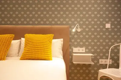 a bedroom with a bed with a yellow pillow at Quiet Loft in Valencia