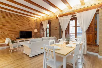 a living room with a table and a couch at Your home at Valencia Cabañal 2 in Valencia