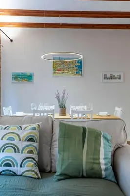 a couch with pillows in a living room at Your home at Valencia Cabañal 2 in Valencia