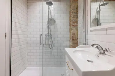 a white bathroom with a shower and a sink at Your home at Valencia Cabañal 2 in Valencia