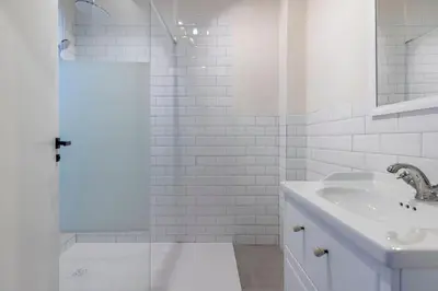 a white bathroom with a sink and a shower at Your home at Valencia Cabañal 2 in Valencia
