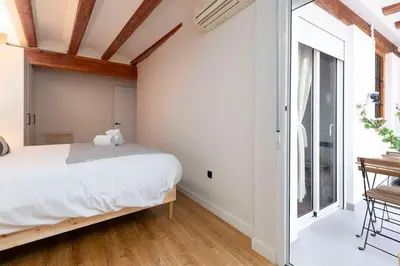 a bedroom with a bed and a large window at Your home at Valencia Cabañal 2 in Valencia