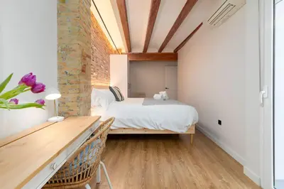 a bedroom with a bed and a brick wall at Your home at Valencia Cabañal 2 in Valencia