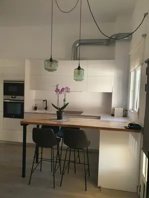a kitchen with a wooden table and chairs at Loft Canet in Canet de Berenguer