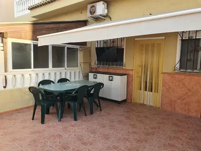 a patio with a table and chairs and a tv at Loft Canet in Canet de Berenguer