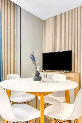 a dining room with a white table and chairs at City Scape Suites in Valencia