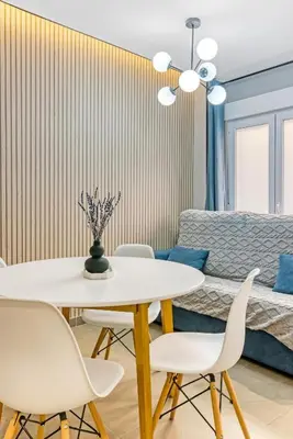 a dining room with a white table and chairs at City Scape Suites in Valencia