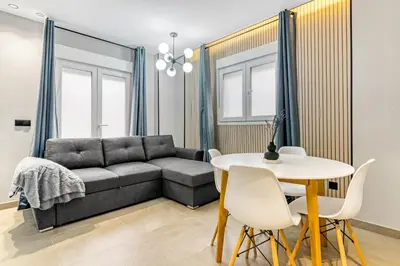 a living room with a couch and a table at City Scape Suites in Valencia