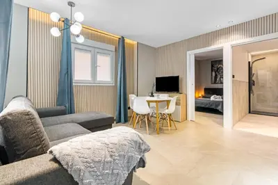 a living room with a couch and a table at City Scape Suites in Valencia