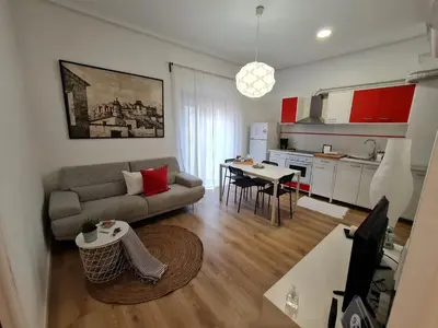 a living room with a couch and a table and a kitchen at Alojamientos Segóbriga Rural (Montaña) in Segorbe