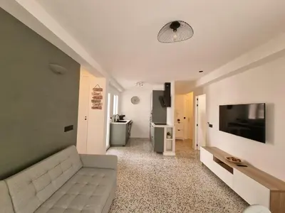 a living room with a couch and a flat screen tv at Relax Degrain in Cullera