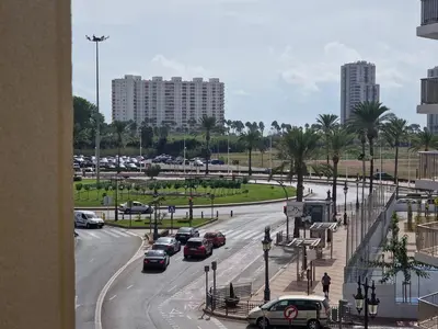 a city street with cars parked on the road at Relax Degrain in Cullera