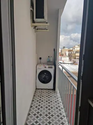 a washing machine in a room with a balcony at Relax Degrain in Cullera