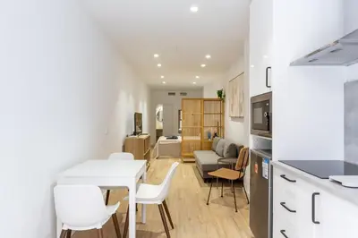 a kitchen and living room with a table and chairs at Nuevo piso cerca de universidad y playa in Valencia