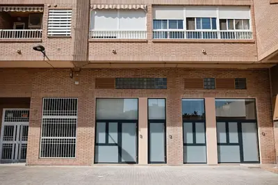 a brick building with four windows and a balcony at Lofts plaza Orense A New and close to the beach in Valencia