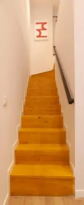 a staircase in a building with wooden floors and a painting at LOFT Accommodative B in Valencia