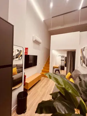 a living room with a couch and a tv at LOFT Accommodative B in Valencia