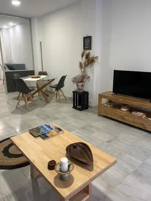 a living room with a coffee table and a flat screen tv at Mediterranéo in Valencia