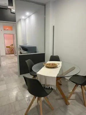 a dining room with a glass table and chairs at Mediterranéo in Valencia