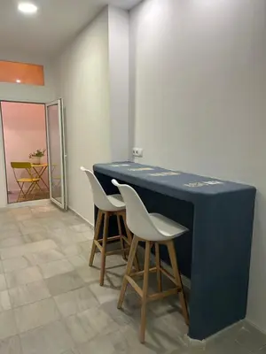 a blue table with two white chairs in a room at Mediterranéo in Valencia