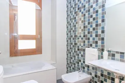 a white bathroom with a sink and a toilet at BET Apartments - Tramontana Apartments in Valencia