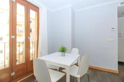 a white dining room with a white table and chairs at BET Apartments - Tramontana Apartments in Valencia