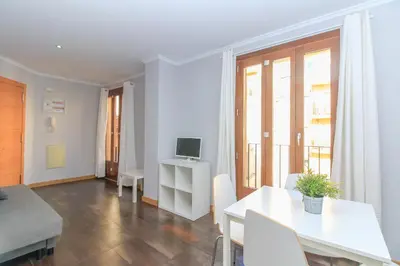 a living room with a white table and a television at BET Apartments - Tramontana Apartments in Valencia